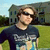 Two side-by-side pixelated images of people in outdoor settings, one showing a person with sunglasses and a dark shirt on grass near a house, the other a close-up of another person's face.