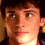Four pixelated facial expressions of a person with brown hair, showing neutral to smiling transitions across the