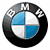 Static pixelated icon of a circular BMW logo with blue and white quadrants, black outer ring, and checkered pattern on top section.