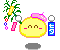 Pixelated yellow circular character with pink hair accessory, green plant prop, and blue text box showing 't' on gray background.