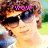 A person with brown curly hair and dark sunglasses appears in four , each displaying different pink pixelated text above the head