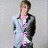 A person in a light blue jacket and white shirt stands against a gray background with pink text overlay changing across frames.