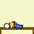 Pixelated character lying on a brown surface with yellow torso, blue limbs, and white circular head against a pale yellow background.
