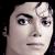 Pixelated close-up of a human face with light skin tone, dark eyebrows, and dark eyes, set against a solid black background.