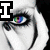 A pixelated image of a stylized face with rainbow-colored eye, black and white makeup, and a large 'I' symbol in the top-left corner.