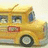 A static image of a yellow school bus with visible text elements arranged around it on a black background.