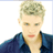 Static pixelated image of a person with short light-colored hair wearing a dark blue jacket against a white background.