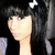 A person with long dark hair and bangs wears a white star-shaped accessory in their hair, positioned against a black background.