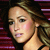 Pixelated close-up of a person with light skin tone, brown hair, and a black sleeveless top against a dark background with purple and red horizontal stripes.