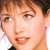 Static pixelated close-up of a person's face with brown hair and light skin tone, cropped to show eyes, nose, mouth, and part of the ear against a white background.