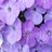 Pixelated purple and white abstract composition with dark irregular shapes against a soft gradient background.