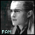 Pixelated grayscale portrait of a person with short hair and a headband, wearing a dark shirt, with 'FAN' text in light blue at bottom left.