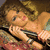 A pixelated image of a woman with curly hair lying on patterned fabric, holding a microphone near her face.