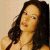 A pixelated image of a woman with long dark hair and light skin, positioned next to green text reading 'Original Icons .com' on a solid background.