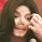 Animated contact sheet of Michael Jackson performing a hand gesture against red background in 4x4 grid layout with 16 sequential frames showing motion progression.