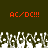 Two identical orange 'AC/DC!!!' text blocks above a of pixelated white and gray figures on a dark green background