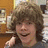 A pixelated image of a person with light brown hair and a gray shirt, alongside text elements on black and gray backgrounds.