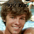A pixelated image of a smiling person with brown hair, showing text above the head that changes from 'luv him' to '(3 ( '