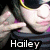 A person wearing dark sunglasses with yellow trim and a striped shirt makes a hand gesture, with text overlays changing across frames.