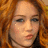 A pixelated image of a person with red hair on the left, next to a bright pink background with red pixelated text reading 'looks like we found ourselves up against a wall.'