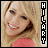 Pixelated image of a smiling person with blonde hair wearing a pink top, split into two side-by-side with vertical text