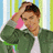 A pixelated image of a person in a green jacket and white shirt holding their head, with blue text reading 'forget love... id rather fall into chocolate' on a split background.
