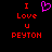 Pixelated red text "I Love U PEYTON" on black background with a pink heart symbol above the word "Love".