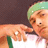 Animated contact sheet showing four sequential frames of a person wearing green headband and white shirt with green trim making hand gestures against dark background.