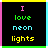 A 4-frame animated contact sheet showing pixelated text "I love neon lights" in varying colors across four quadrants with a black background and colored borders.