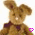 Animated brown bunny with dark purple bow tie, white nose, and pink heart symbol changing to black heart on right side.