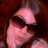 Pixelated image of a person with brown hair and sunglasses, pink text reading "Megii Leighh©33" on the right side.