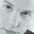 Pixelated grayscale close-up of a person's face showing eyes, nose, and mouth with visible pixelation and low resolution.