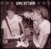 Animated sequence of two people in a sepia-toned concert scene with one person holding a white electric guitar and the other leaning toward them, surrounded by star symbols and 'uncertain' text.