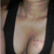 A close-up of a person's chest area with black straps, showing subtle movement in the fabric and skin texture across frames.