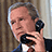 A pixelated image of a person holding a black rotary phone to their ear, with text reading "whoa" and "baby!" on separate dark