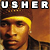 Pixelated static image of a person with yellow hair and brown tones, featuring large white text "USHER" at the top against a dark background.