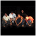 Four show a group of people in various poses: seated, jumping, singing, and playing drums, with visible clothing and background details