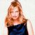 A pixelated image of a woman with long light brown hair wearing a dark blue sleeveless dress against a white background, next to green text on a dark green background.