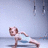 Animated sequence of a person in a plank pose with arms extended, performing a side-to-side movement against a light gray background with hanging objects.