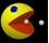 Pixelated yellow circular character with open mouth, blue eye, and white dot on black background.