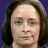 A pixelated contact sheet of two frames showing a person with long brown hair against a blue background on the left and black text reading "It's official I can't have children" on the right, displayed in a 2x1 grid layout.