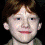Three pixelated headshots of a person with red hair and light skin, arranged in a against varying backgrounds