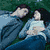 Four distinct scenes show characters in various poses and settings, including a couple lying down, a person with long hair, and two people close together.