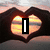 A heart-shaped hands frame a sunset over water with text changing from 'I' to 'Love' to 'MUM'
