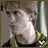 A pixelated animated icon shows a person with light skin and dark hair in profile, wearing a white shirt against a gray background.