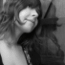 Black-and-white and color versions of a person with long wavy hair wearing a dark top with light floral patterns, shown in profile view.