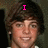 Pixelated image of a person with brown hair and light skin, wearing white clothing against dark background.