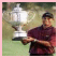 A pixelated image of a person holding a large trophy, with bold yellow text reading "Tiger Woods Rules" on the right side.