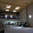 A blurry static image of a dimly lit interior space with multiple light fixtures and indistinct architectural elements.