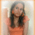 A person in an orange top with long dark hair appears in a of four , with the bottom-right blank